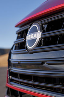 Close-up of Nissan vehicle grille with chrome and black accents