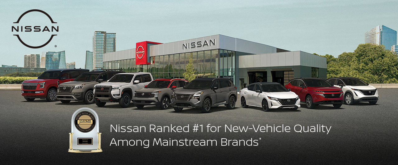 Lineup of new Nissan vehicles in front of a Nissan dealership, highlighting J.D. Power quality award.